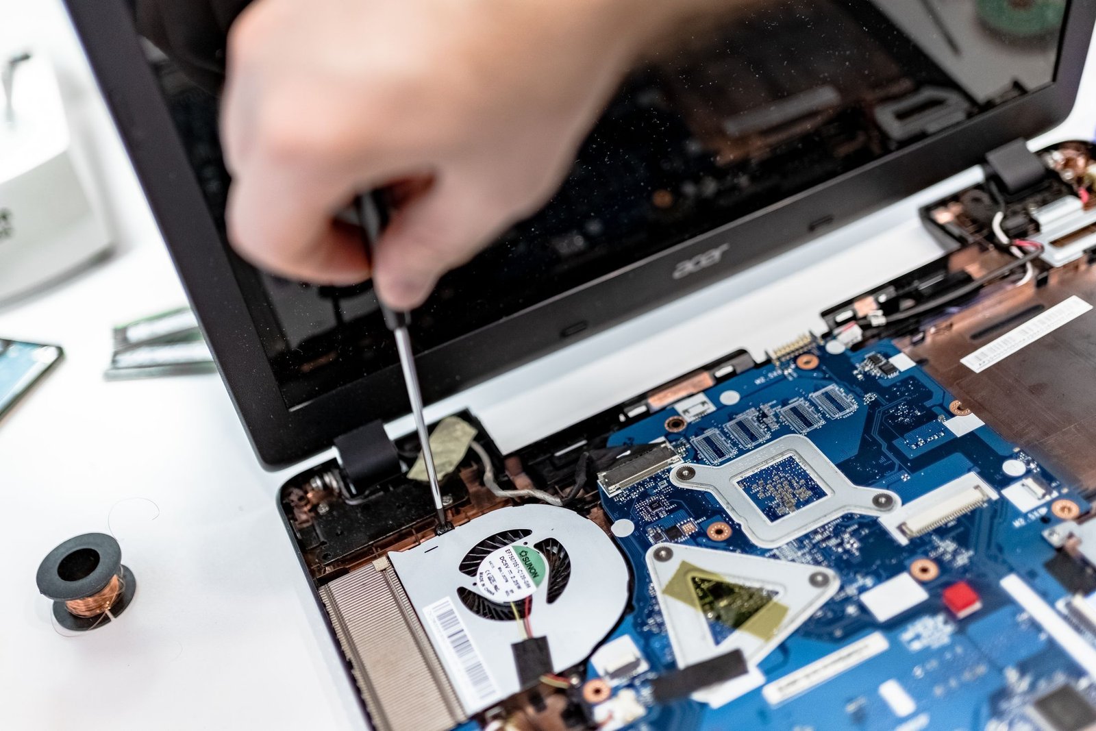 Technician diagnosing an open laptop